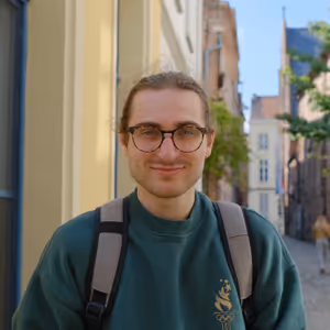 Nick facing camera with quaint street behind him